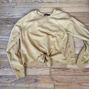 Crewneck with tie at bottom.